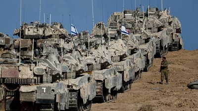 An Israeli soldier walks next to military vehicles near the border with Gaza, in Israel September 17, 2025. (Reuters)