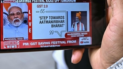 A man watches a live telecast of Prime Minister Narendra Modi addressing the nation, on his mobile phone in Bengaluru on September 21, 2025. (AFP) A man watches a live telecast of Prime Minister Narendra Modi addressing the nation, on his mobile phone in Bengaluru on September 21, 2025. (AFP)