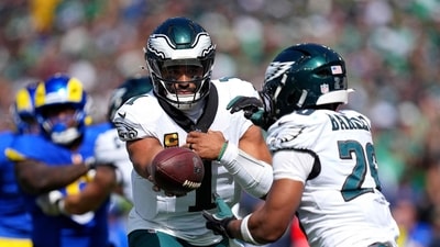 Jalen Hurts #1 hands off the ball to Saquon Barkley #26 of the Philadelphia Eagles during the second quarter against the Los Angeles Rams (Getty Images via AFP) Jalen Hurts #1 hands off the ball to Saquon Barkley #26 of the Philadelphia Eagles during the second quarter against the Los Angeles Rams (Getty Images via AFP)