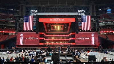 Attendees gather in the stands as media set up ahead of the memorial service for political activist Charlie Kirk at State Farm Stadium on September 21, 2025 in Glendale, Arizona. (Getty Images via AFP)
