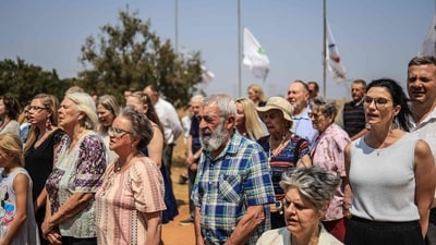 Residents of Kleinfontein sing their anthem after hoisting their flags to fly at half-mast in honour of US youth activist and influencer Charlie Kirk in Kleinfontein, an Afrikaner settlement near Pretoria, on September 21, 2025. US President Donald Trump and top officials in his administration will lead tributes to Charlie Kirk on September 21, 2025 at a stadium gathering in Arizona, after the influential conservative activist was gunned down last week.
Kirk, 31, was fatally shot in the neck on September 10 while speaking at a Utah university as part of his popular public debate series. (Photo by Phill Magakoe / AFP) (AFP) Residents of Kleinfontein sing their anthem after hoisting their flags to fly at half-mast in honour of US youth activist and influencer Charlie Kirk in Kleinfontein, an Afrikaner settlement near Pretoria, on September 21, 2025. US President Donald Trump and top officials in his administration will lead tributes to Charlie Kirk on September 21, 2025 at a stadium gathering in Arizona, after the influential conservative activist was gunned down last week.
Kirk, 31, was fatally shot in the neck on September 10 while speaking at a Utah university as part of his popular public debate series. (Photo by Phill Magakoe / AFP) (AFP)