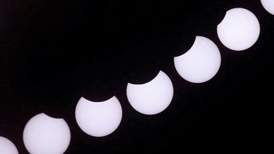 A composite image of 7 separate photographs taken with a single fixed camera shows the partial solar eclipse seen from Castillo del Romeral, on the island of Gran Canaria. Spain. (REUTERS)