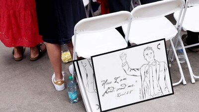 A sign rests against a chair ahead of the memorial service for political activist Charlie Kirk at State Farm Stadium on September 21, 2025 in Glendale, Arizona. Kirk, the CEO and co-founder of Turning Point USA, was shot and killed on September 10th while speaking at an event during his "American Comeback Tour" at Utah Valley University. Eric Thayer/Getty Images/AFP (Photo by Eric Thayer / GETTY IMAGES NORTH AMERICA / Getty Images via AFP) (Getty Images via AFP) A sign rests against a chair ahead of the memorial service for political activist Charlie Kirk at State Farm Stadium on September 21, 2025 in Glendale, Arizona. Kirk, the CEO and co-founder of Turning Point USA, was shot and killed on September 10th while speaking at an event during his "American Comeback Tour" at Utah Valley University. Eric Thayer/Getty Images/AFP (Photo by Eric Thayer / GETTY IMAGES NORTH AMERICA / Getty Images via AFP) (Getty Images via AFP)
