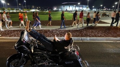 A man rests on a motorbike outside State Farm Stadium, on the day of a memorial service for slain conservative commentator Charlie Kirk, in Glendale, Arizona, U.S., September 21, 2025.  REUTERS/Carlos Barria (REUTERS)