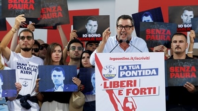People hold placards, some of them with images of slain U.S. conservative commentator Charlie Kirk, as Italy's Deputy Prime Minister and League party leader Matteo Salvini applauds on stage at the League party annual rally in Pontida, Italy, September 21, 2025. The placards read "I am Charlie Kirk" and "without fear". REUTERS/Remo Casilli (REUTERS)