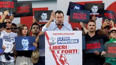 People hold placards, some of them with images of slain U.S. conservative commentator Charlie Kirk, as Italy's Deputy Prime Minister and League party leader Matteo Salvini speaks on stage at the League party annual rally in Pontida, Italy, September 21, 2025. The placards read "I am Charlie Kirk" and "without fear". REUTERS/Remo Casilli REFILE - CORRECTING ACTION FROM "APPLAUDS" TO "SPEAKS". (REUTERS)