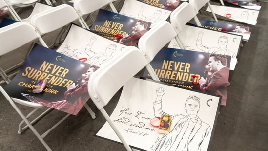 Signs are placed on empty chairs with tissues and bracelets during a memorial service for Turning Point USA founder Charlie Kirk at State Farm Stadium in Glendale, Arizona, US, on Sunday, Sept. 21, 2025.(Bloomberg)