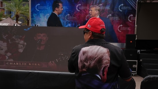 Joe Sena, wearing a shirt with President Donald Trump on it, walks around outside before a memorial for conservative activist Charlie Kirk, Sunday, Sept. 21, 2025, at State Farm Stadium in Glendale, Ariz. (AP Photo/Jae C. Hong)(AP)