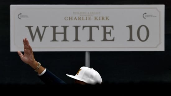 A person prays as people gather to attend a memorial service for slain conservative commentator Charlie Kirk at State Farm Stadium, on the day of a memorial service for slain conservative commentator Charlie Kirk, in Glendale, Arizona, U.S., September 21, 2025. REUTERS/Carlos Barria(REUTERS)