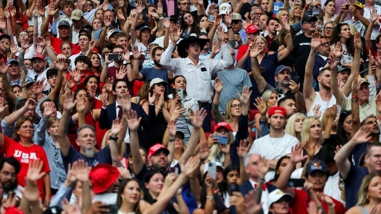 People raise their hands, as they gather on the day of a memorial service for slain conservative commentator Charlie Kirk at State Farm Stadium, in Glendale, Arizona, U.S., September 21, 2025. REUTERS/Daniel Cole(REUTERS)