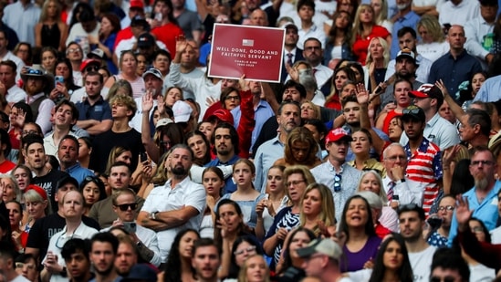 A person holds a placard in memory of slain conservative commentator Charlie Kirk, as people gather to attend his memorial service, at State Farm Stadium, in Glendale, Arizona, U.S., September 21, 2025. REUTERS/Daniel Cole(REUTERS)