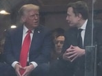 President Donald Trump, left, and Elon Musk talk during a memorial for Charlie Kirk.