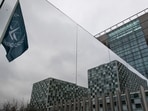 The flag of the International Criminal Court is reflected in a mirrored wall of the building in The Hague, Netherlands. The flag of the International Criminal Court is reflected in a mirrored wall of the building in The Hague, Netherlands.