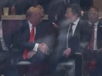 US President Donald Trump and Tesla CEO Elon Musk shake hands during the public memorial service for right-wing activist Charlie Kirk at State Farm Stadium in Glendale, Arizona, on September 21, 2025. (Photo by CHARLY TRIBALLEAU / AFP)