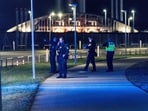 Police officers walk after all traffic has been closed at the Copenhagen Airport due to drone reports in Copenhagen, Denmark 