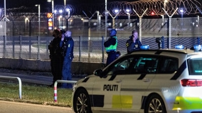 Police officers stand guard after all traffic has been closed at the Copenhagen Airport due to drone reports in Copenhagen, Denmark (via REUTERS)