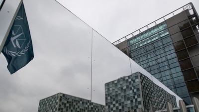 The flag of the International Criminal Court is reflected in a mirrored wall of the building in The Hague, Netherlands. (AP File) The flag of the International Criminal Court is reflected in a mirrored wall of the building in The Hague, Netherlands. (AP File)