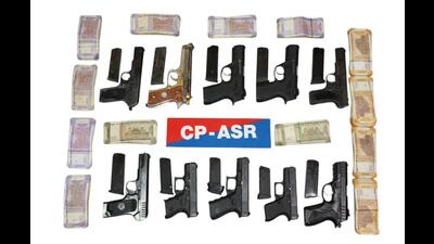 The 10 pistols,  ₹2.5 lakh Hawala money recovered from the accused in Amritsar on Monday. (HT File)