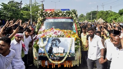 People gather around the vehicle carrying the mortal remains of singer Zubeen Garg as they are taken to his residence from Guwahati airport, Sunday, Sept. 21, 2025. (PTI) People gather around the vehicle carrying the mortal remains of singer Zubeen Garg as they are taken to his residence from Guwahati airport, Sunday, Sept. 21, 2025. (PTI)
