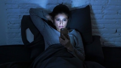 Nighttime scrolling may seem relaxing, but the blue light on your phone confuses the brain. (Shutterstock) Nighttime scrolling may seem relaxing, but the blue light on your phone confuses the brain. (Shutterstock)