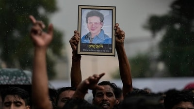 A fan holds a photograph of Zubeen Garg during the homage ceremony in Guwahati. (AP) A fan holds a photograph of Zubeen Garg during the homage ceremony in Guwahati. (AP)
