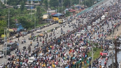 People gather as a flower-decked ambulance carrying the mortal remains of popular Assam singer Zubeen Garg, along with other vehicles, proceeds towards his Kahilipara residence from the airport (PTI) People gather as a flower-decked ambulance carrying the mortal remains of popular Assam singer Zubeen Garg, along with other vehicles, proceeds towards his Kahilipara residence from the airport (PTI)