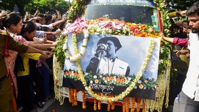 People touch the vehicle carrying the mortal remains of singer Zubeen Garg as they are taken to his residence from Guwahati airport. (PTI) People touch the vehicle carrying the mortal remains of singer Zubeen Garg as they are taken to his residence from Guwahati airport. (PTI)