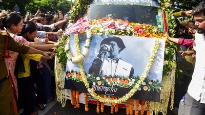 People touch the vehicle carrying the mortal remains of singer Zubeen Garg as they are taken to his residence from Guwahati airport. (PTI)