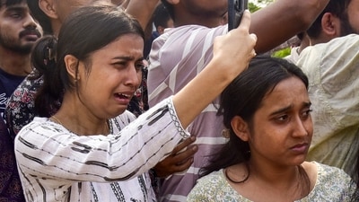 People mourn and take pictures as the mortal remains of singer Zubeen Garg are taken to his residence from Guwahati airport on September 21 (PTI) People mourn and take pictures as the mortal remains of singer Zubeen Garg are taken to his residence from Guwahati airport on September 21 (PTI)