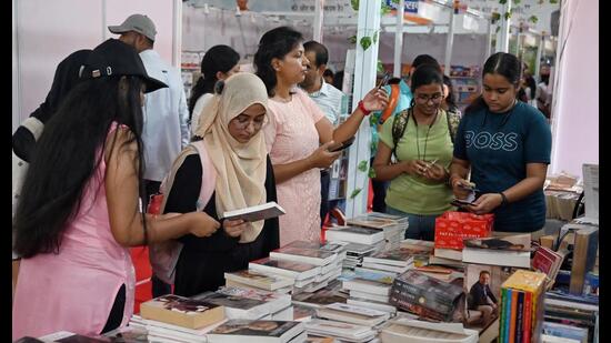 Visitors browse books on the third day of the Gomti Book Festival at Lucknow University on Monday. (Mushtaq Ali/HT Photo)