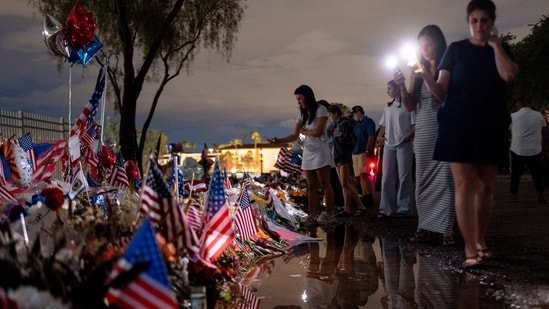 Mourners visit a tribute for slain conservative commentator Charlie Kirk at the headquarters of Turning Point USA, in Phoenix, Arizona.(Cheney Orr/REUTERS)