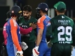 Pakistan's Haris Rauf (3R) speaks with India's Abhishek Sharma (L) as Shubman Gill (2R) watches