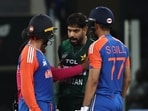 Pakistan's Haris Rauf (C) speaks with India's Abhishek Sharma (L) as Shubman Gill watches