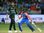 India's Tilak Varma (R) runs between the wickets as Pakistan's Shaheen Shah Afridi watches India's Tilak Varma (R) runs between the wickets as Pakistan's Shaheen Shah Afridi watches