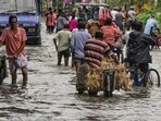Kolkata: Commuters make their way through a waterlogged road following rain, in Kolkata, Tuesday, Sept. 23, 2025. (PTI Photo/Manvender Vashist Lav)(PTI09_23_2025_000096B)