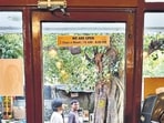 The old café stands across the lane from a Mother Dairy booth, close to a luscious peepal tree.