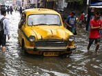 Commuters wade through waterlogged streets due to heavy late-night rain in Kolkata on Tuesday, September 23, 2025. (Samir Jana/ Hindustan Times)
