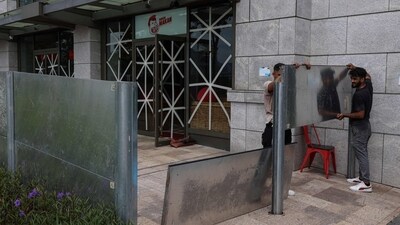 Workers install waterproof steel plates to protect against flooding from Super Typhoon Ragasa, in Hong Kong, China, September 23, 2025. (REUTERS)