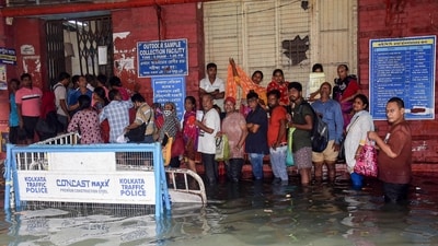 People seek shelter inside a hospital premise after knee deep water inundated several parts of the city today after heavy rain. (Utpal Sarkar/ANI) People seek shelter inside a hospital premise after knee deep water inundated several parts of the city today after heavy rain. (Utpal Sarkar/ANI)