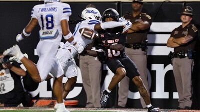 Wide receiver Sam Jackson V of the Oklahoma State Cowboys can't get a hold of the ball under coverage from safety Lento Smith Jr. of the Tulsa Golden Hurricane. (Getty Images via AFP) Wide receiver Sam Jackson V of the Oklahoma State Cowboys can't get a hold of the ball under coverage from safety Lento Smith Jr. of the Tulsa Golden Hurricane. (Getty Images via AFP)