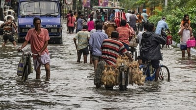 Kolkata: Commuters make their way through a waterlogged road following rain, in Kolkata, Tuesday, Sept. 23, 2025. (PTI Photo/Manvender Vashist Lav)(PTI09_23_2025_000096B) (PTI)