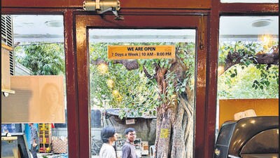 The old café stands across the lane from a Mother Dairy booth, close to a luscious peepal tree. The old café stands across the lane from a Mother Dairy booth, close to a luscious peepal tree.
