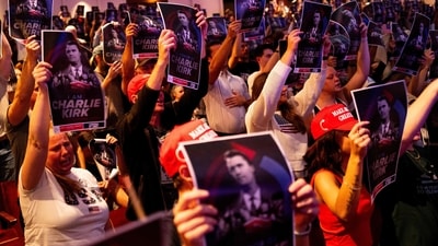 MINNEAPOLIS, MINNESOTA - SEPTEMBER 22: Attendees hold up posters of Charlie Kirk during the "American Comeback Tour" event at Northrop Auditorium on the University of Minnesota campus on September 22, 2025 in Minneapolis, Minnesota. (Photo by Stephen Maturen / GETTY IMAGES NORTH AMERICA / Getty Images via AFP) (Getty Images via AFP) MINNEAPOLIS, MINNESOTA - SEPTEMBER 22: Attendees hold up posters of Charlie Kirk during the "American Comeback Tour" event at Northrop Auditorium on the University of Minnesota campus on September 22, 2025 in Minneapolis, Minnesota. (Photo by Stephen Maturen / GETTY IMAGES NORTH AMERICA / Getty Images via AFP) (Getty Images via AFP)