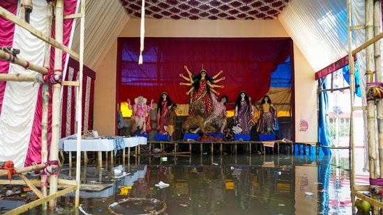As Durga Puja advances the city of Joy Kolkata, an idol setup in a pandal is seen to be placed on an elevated pedestal to keep the rainwater at bay.(Swapan Mahapatra/PTI)