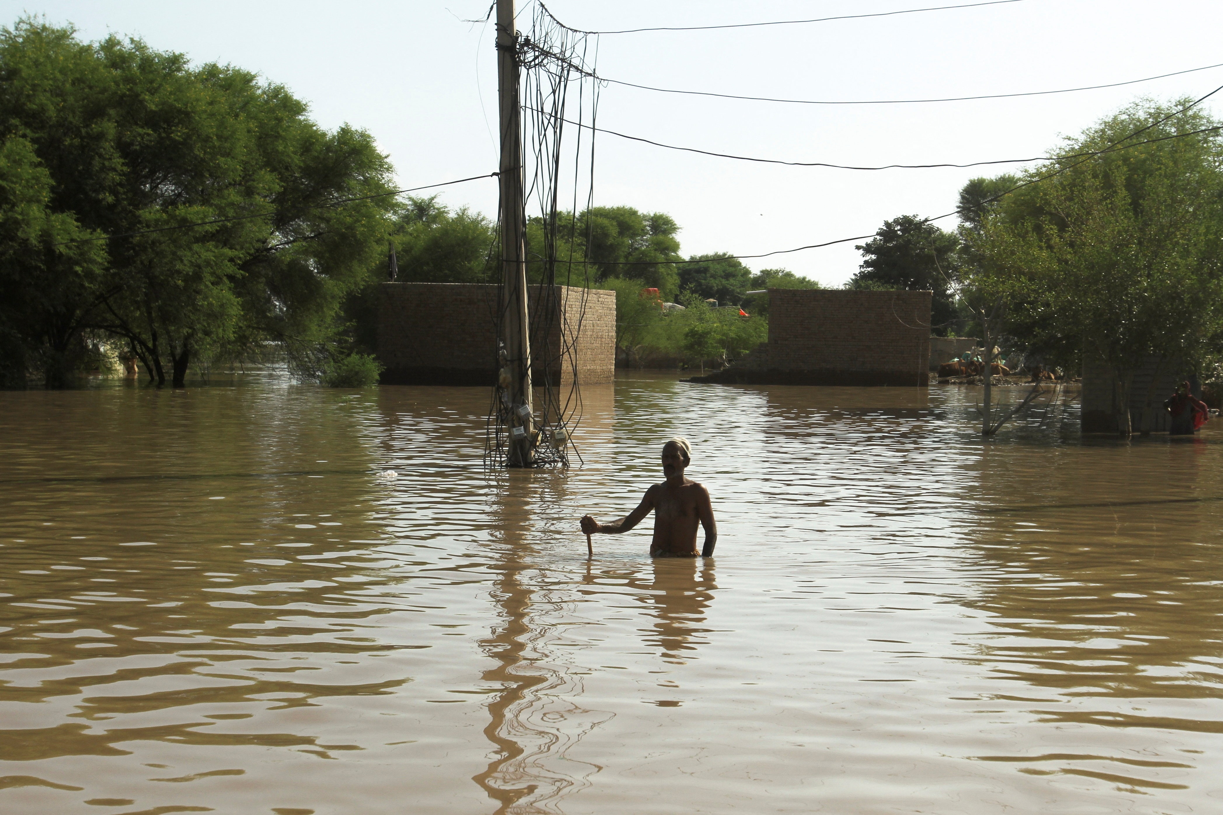 A water scale stands amidst floodwater at the Guddu Barrage in Kashmore, Sindh province, Pakistan. (REUTERS)