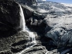 A drone view shows water from melting ice running down the side of the Turtmann glacier on a warm summer day, amid climate change, in Turtmann, Switzerland on September 3. (REUTERS) A drone view shows water from melting ice running down the side of the Turtmann glacier on a warm summer day, amid climate change, in Turtmann, Switzerland on September 3. (REUTERS)