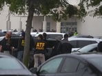 Law enforcement gather at a staging area close to a US. Immigration and Customs Enforcement office after a reported shooting Law enforcement gather at a staging area close to a US. Immigration and Customs Enforcement office after a reported shooting