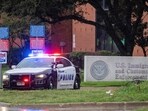 Law enforcement personnel respond at the scene of a shooting at an Immigration and Customs Enforcement (ICE) field office in Dallas
