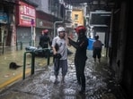 A man receives instruction of an emergency team member after he was rescued from his residence during the passage of Super Typhoon Ragasa.