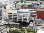 The collapse of the edge of the road in front of a police station left the building's underground construction exposed. 